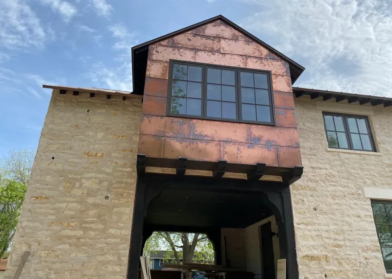 Copper metal panel facade on a stone building for Roof Repair in North Royalton